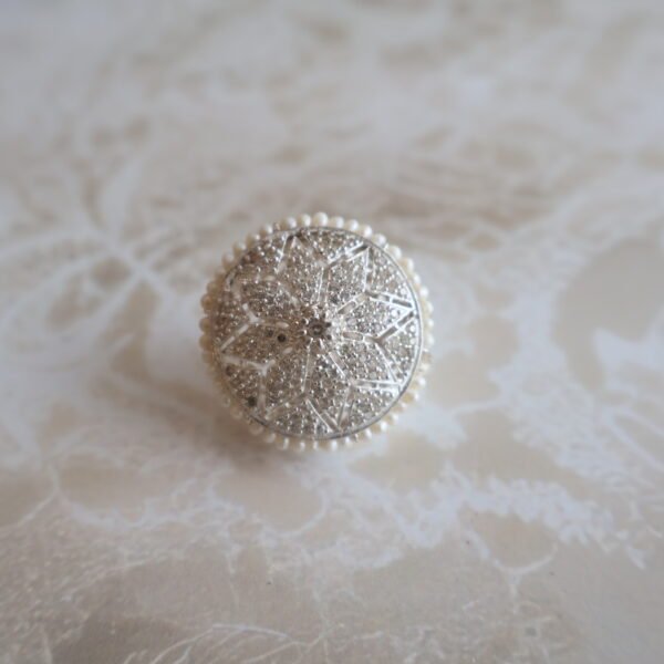 92.5 silver Rakhri crafted with sparkling American diamonds — a graceful forehead ornament for traditional occasions.